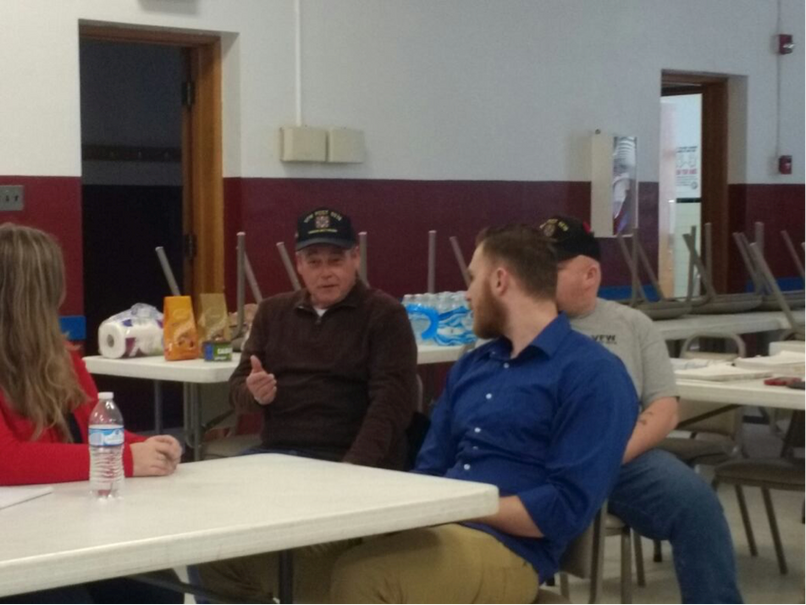 Veterans Advocate Alex Jonese (blue shirt) provides reassurance to a veteran of VFW Post 5578 during the Veterans Advocacy Clinic’s recent trip to Madison, West Virginia. 
