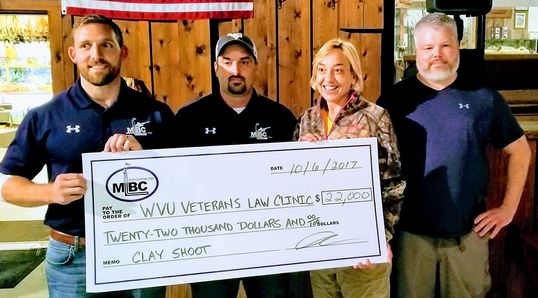 WVU Veterans Advocacy Clinic accepts check for clay shoot fundraiser 2017